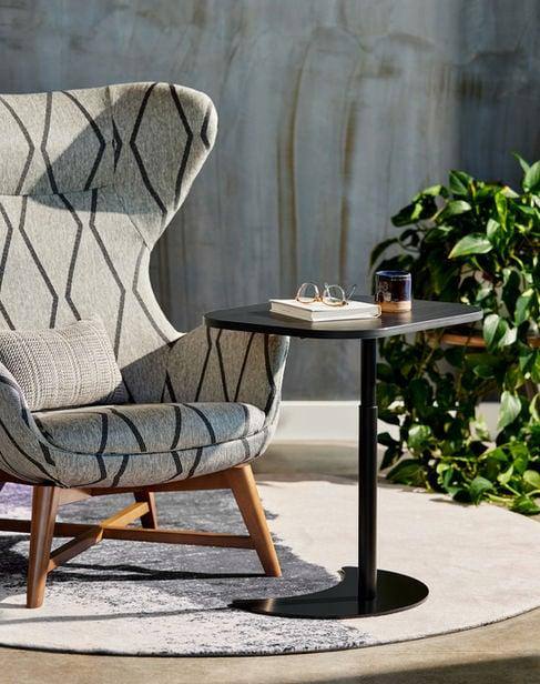 Idara patterned wing chair beside a small table