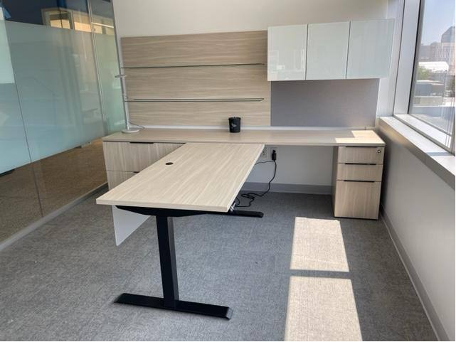 MossRehab private office with height-adjustable desk and overhead storage