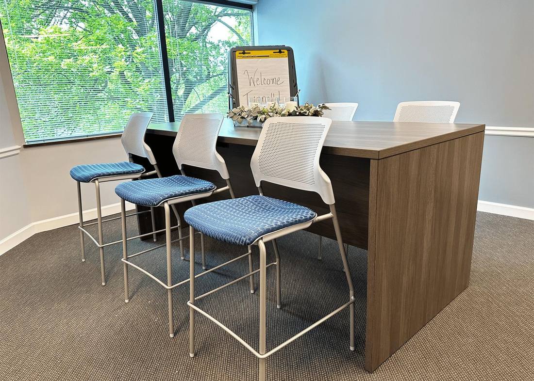 Tunnell café-height collaboration table with stools by a window